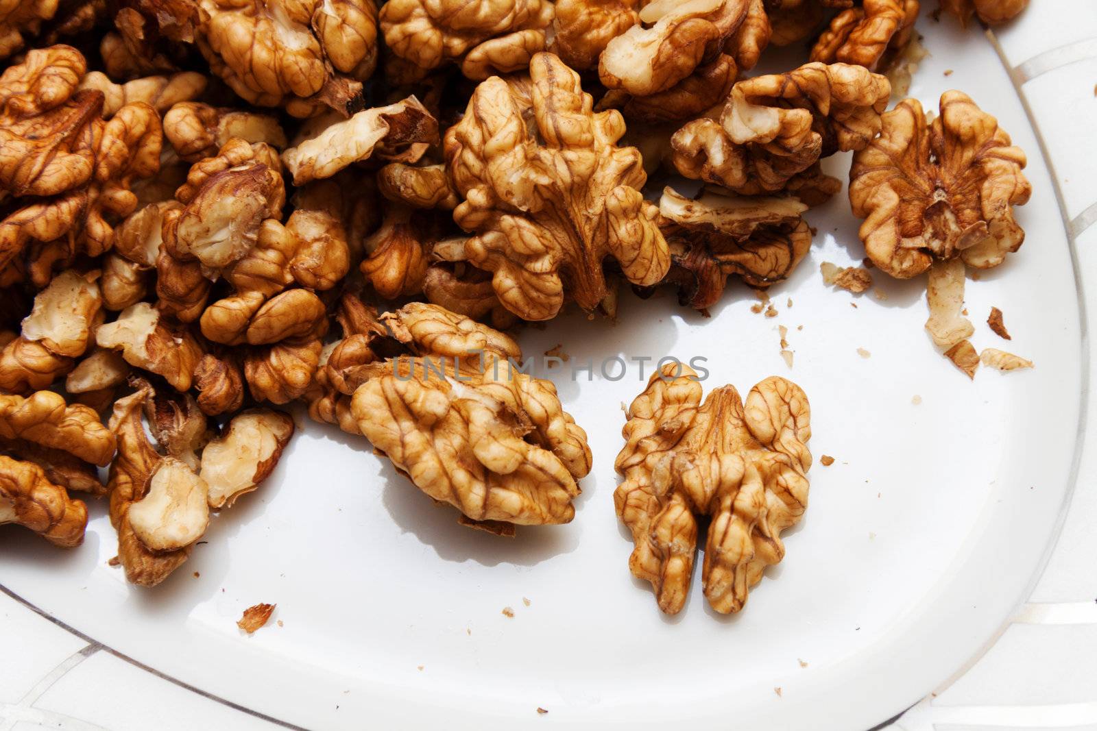 Raw wallnuts in a plate, horizontal shot