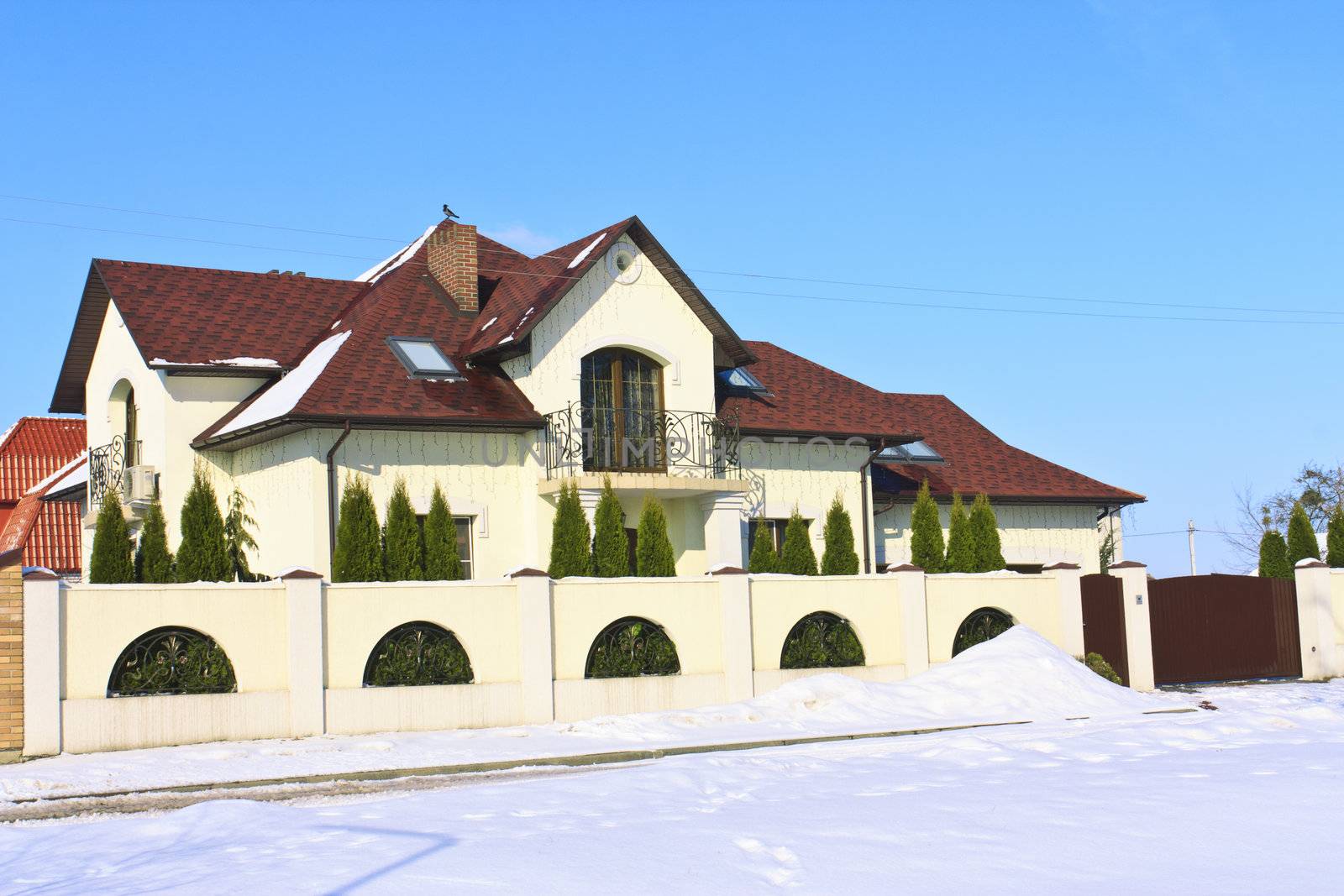 The typical town house in the winter on a background of blue sky