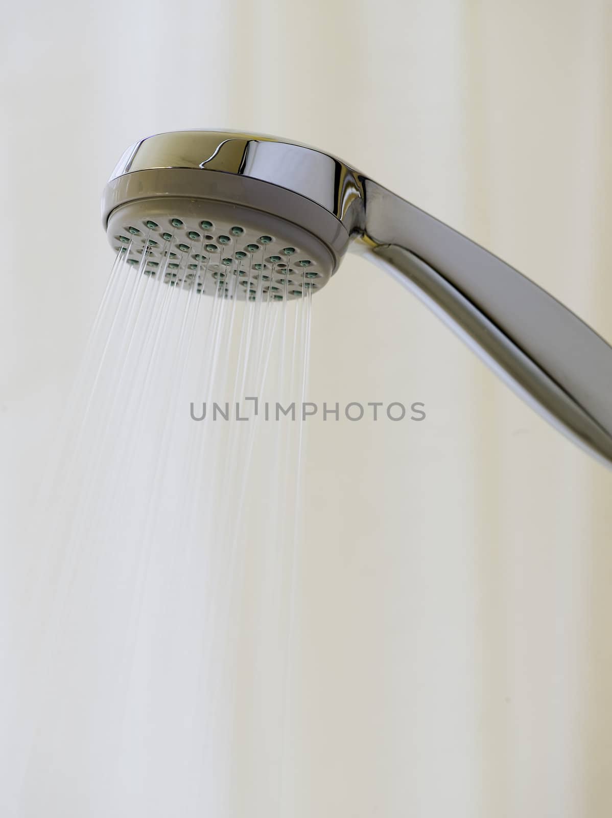Showerhead with spraying water on background