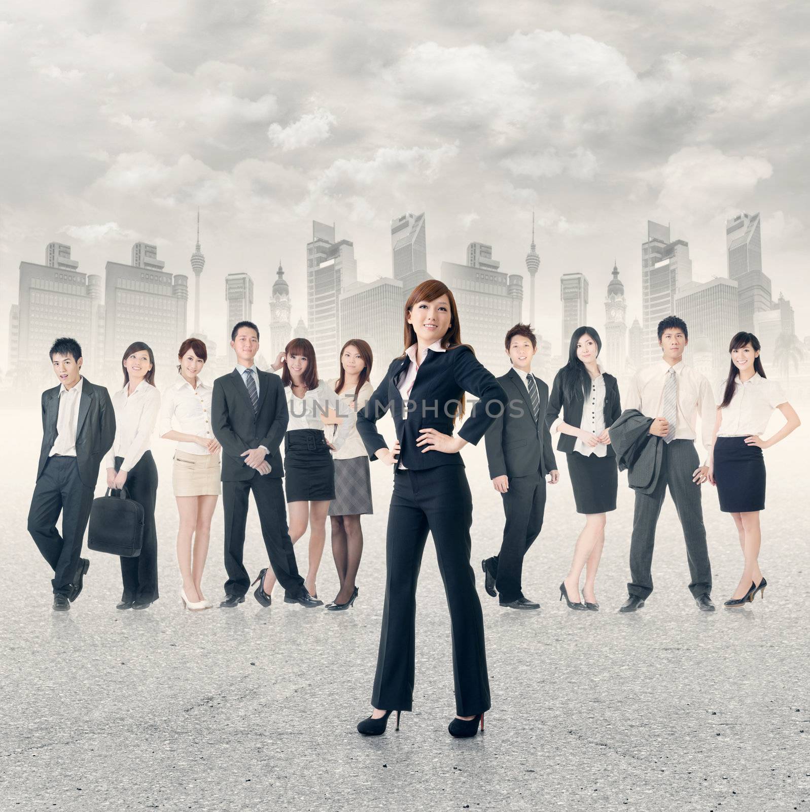 Confident business manager with her business team stand on road in modern city.