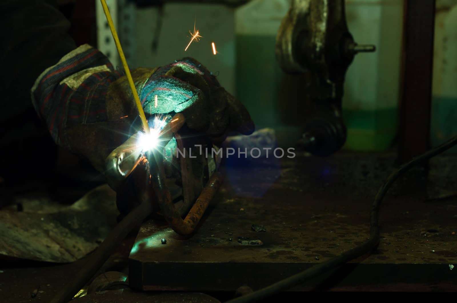 Welding in industrial enviroment with white sparks