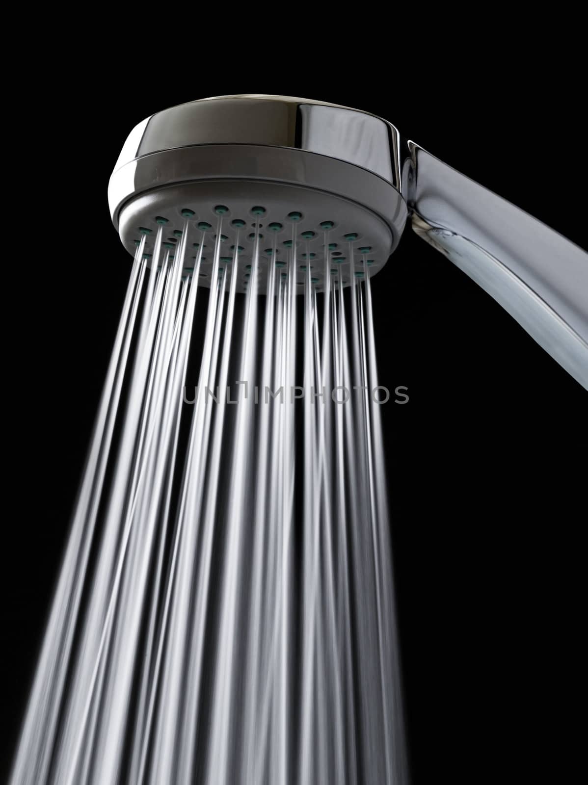 Detailed shot of a shower-head with shower spray. Vertical orientation.
The jets of water are taken at a slow speed por provide movement.