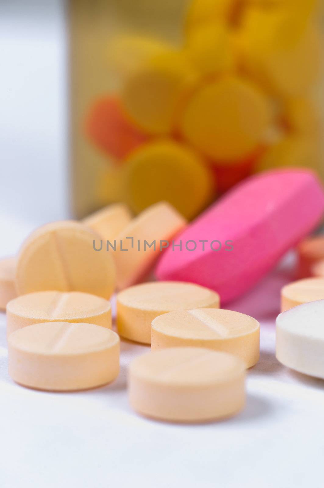 Pills laying very peacefully on white isolated background