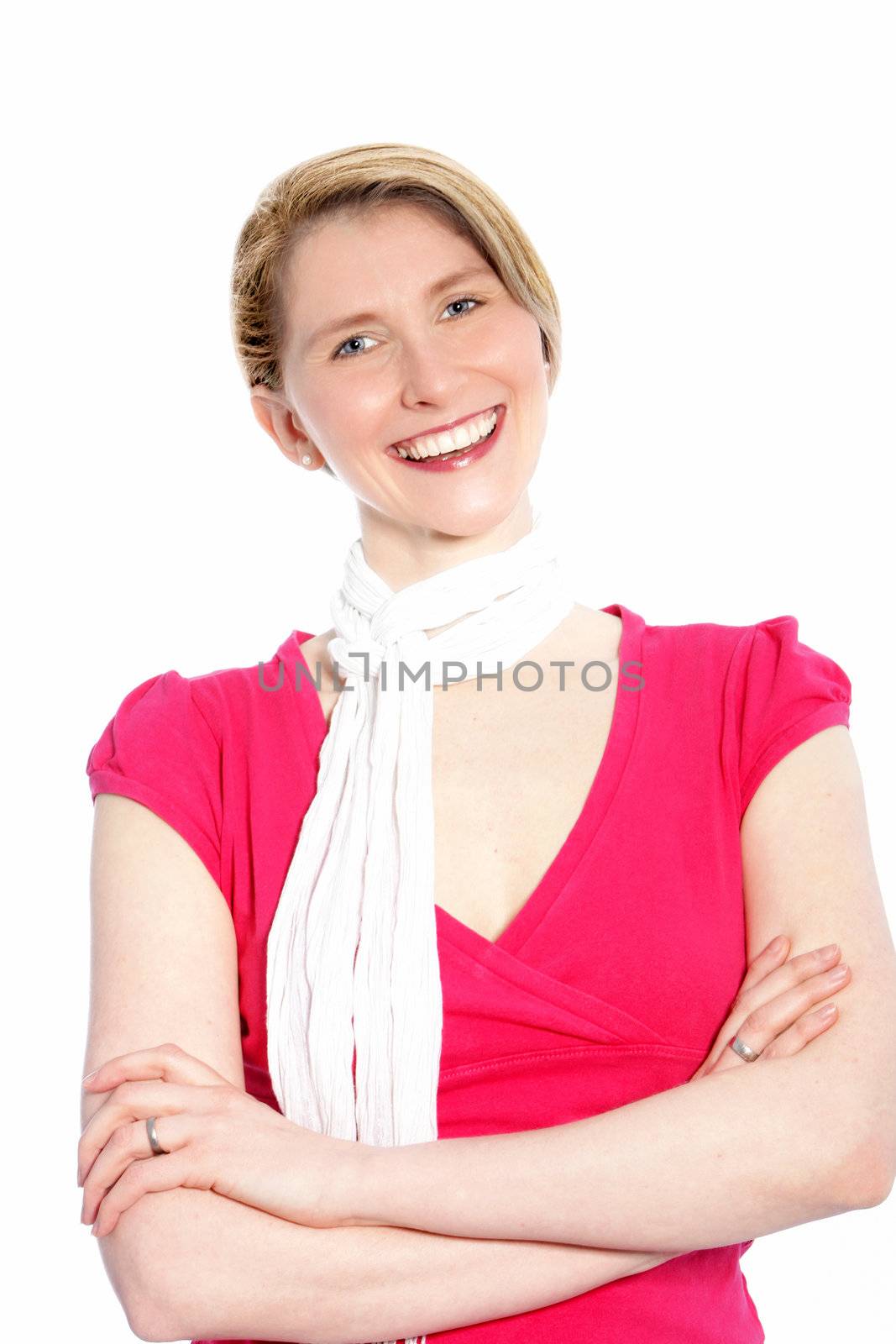 Joyful stylish blond woman standing with her arms folded smiling happily at the camera isolated on white