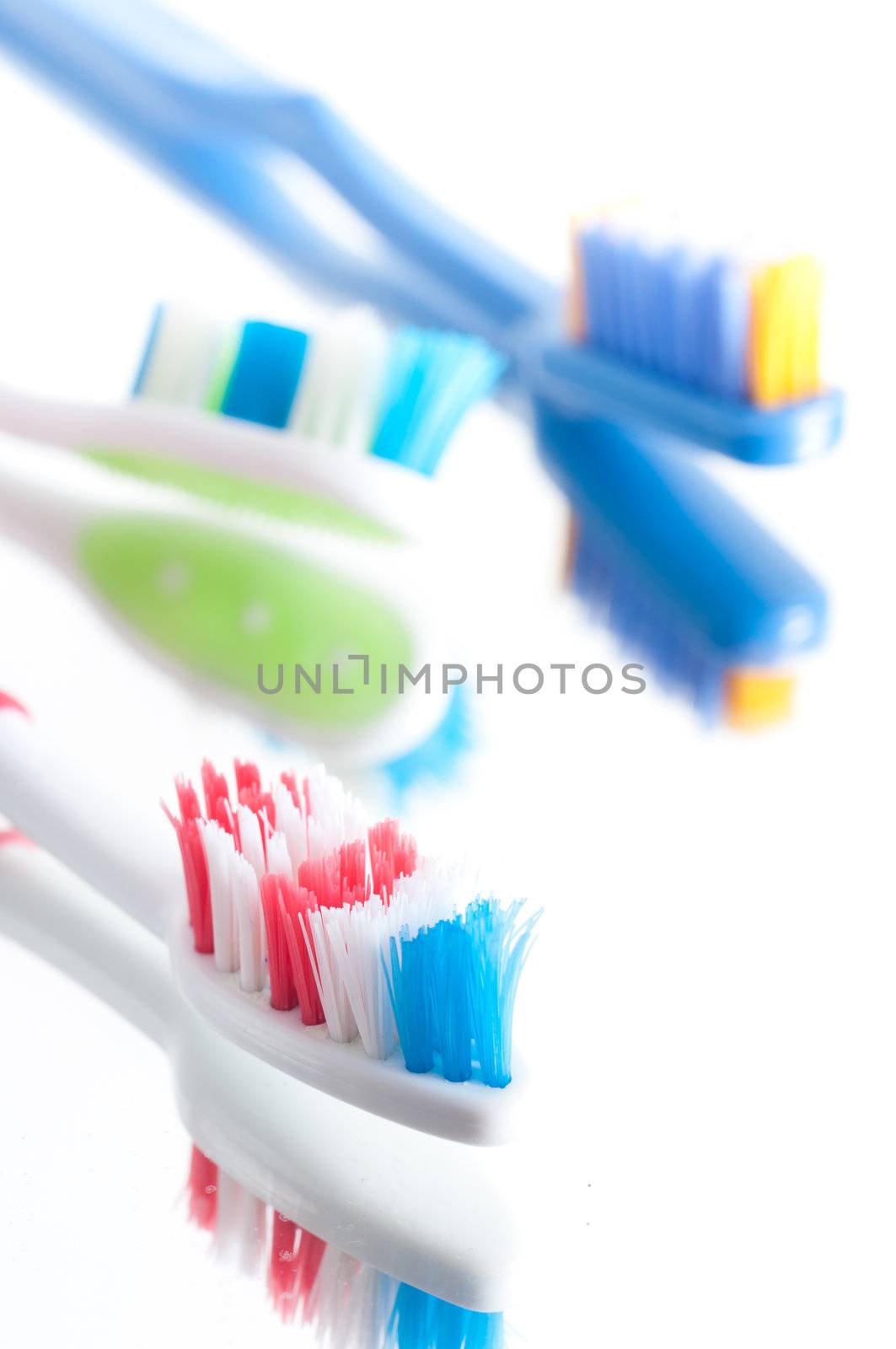 Closeup colorful toothbrush on a white background by svedoliver