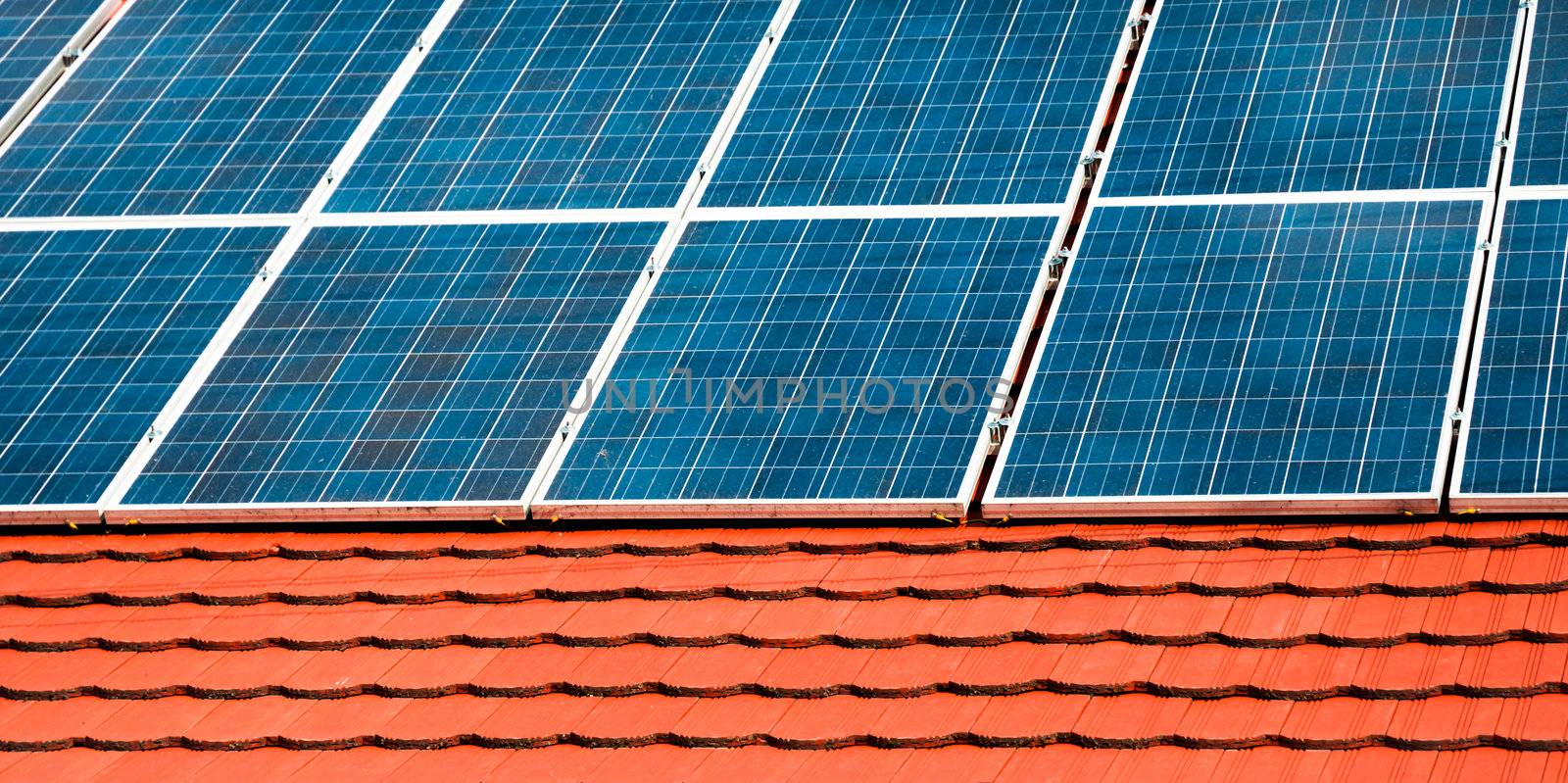 Cells of solar energy panels on the roof of a building by svedoliver