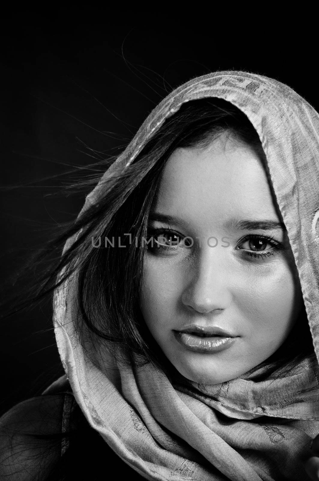 Closeup of a beautiful girl in scarf in black and white