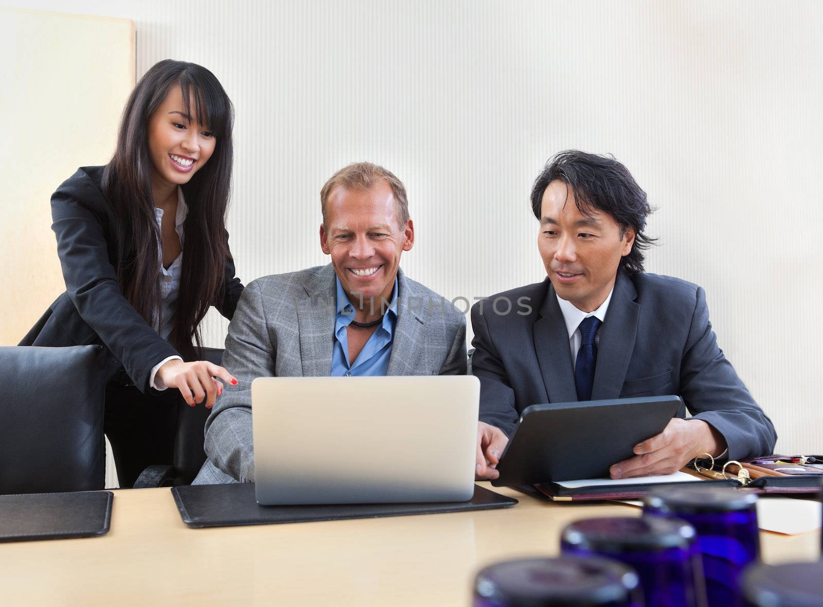 Group of diverse colleagues working on laptop