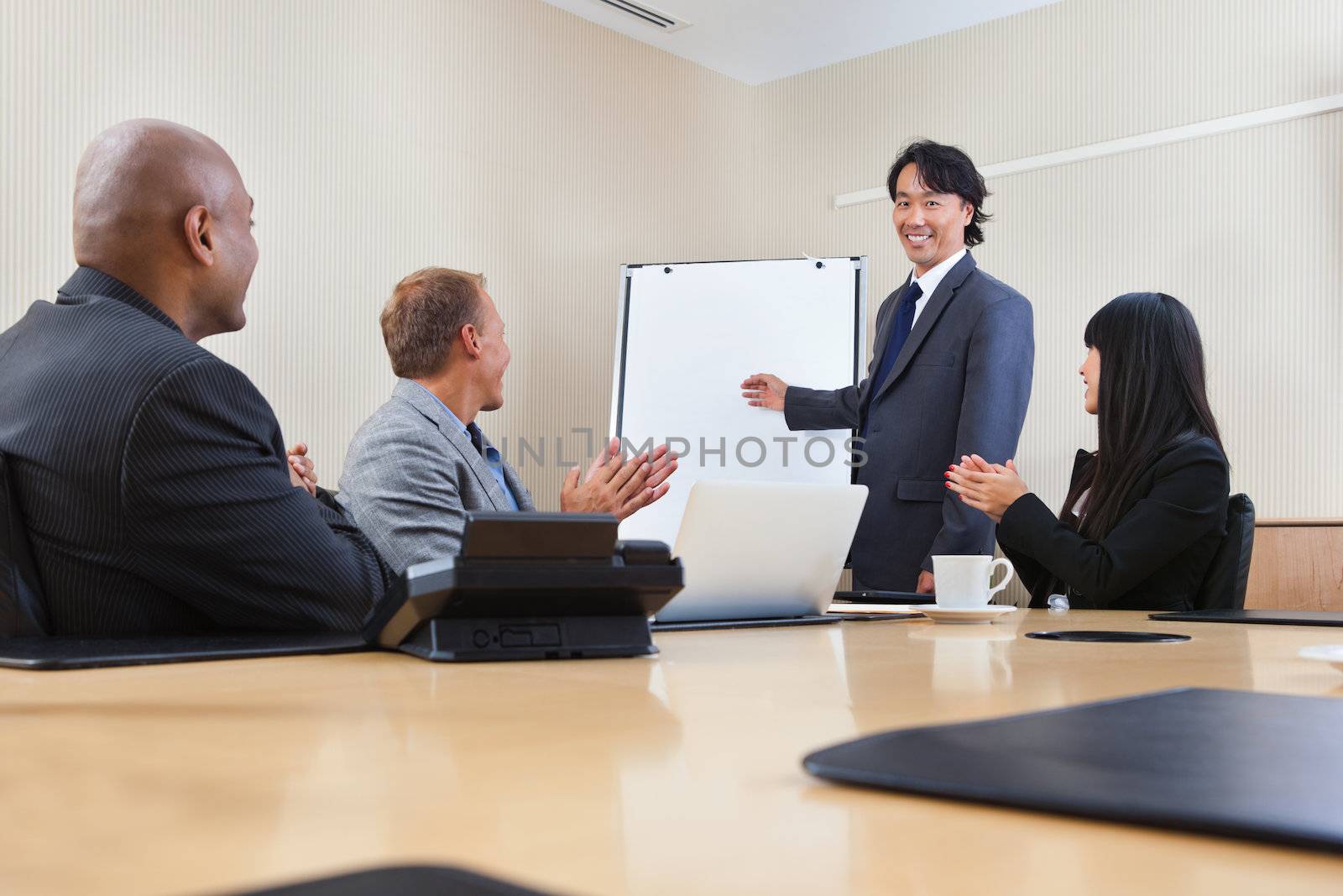 Man giving a presentation to associates by leaf