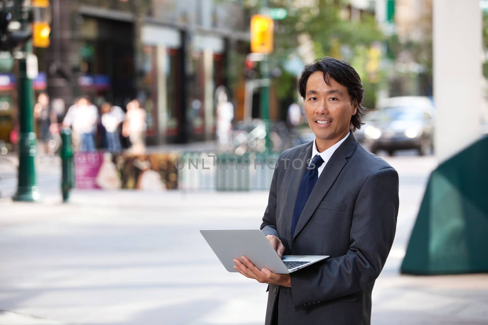 Business Man Portrait Outdoor with Laptop by leaf