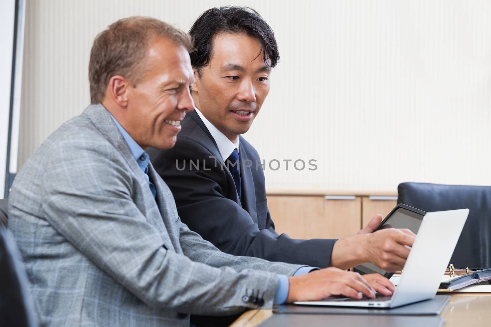 Two multi-ethnic colleagues working together on a computer