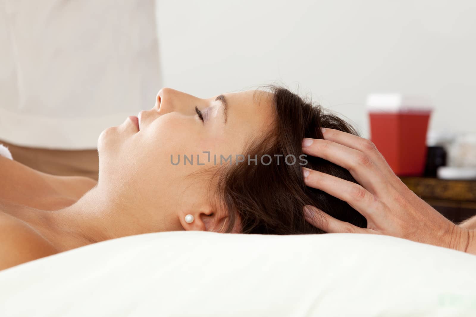 Young attractive woman receiving head massage