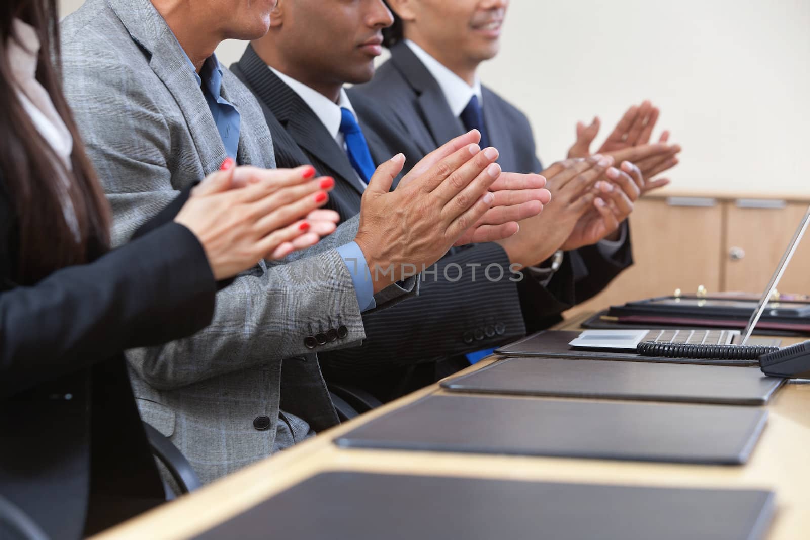Business team applauding by leaf
