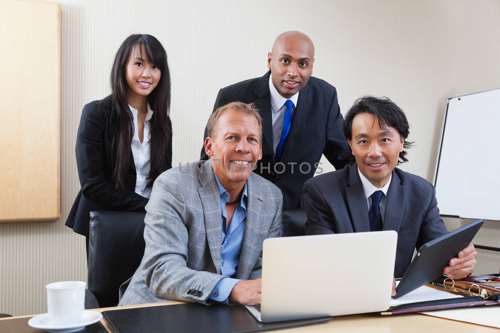 Portrait of multi ethnic business people by leaf