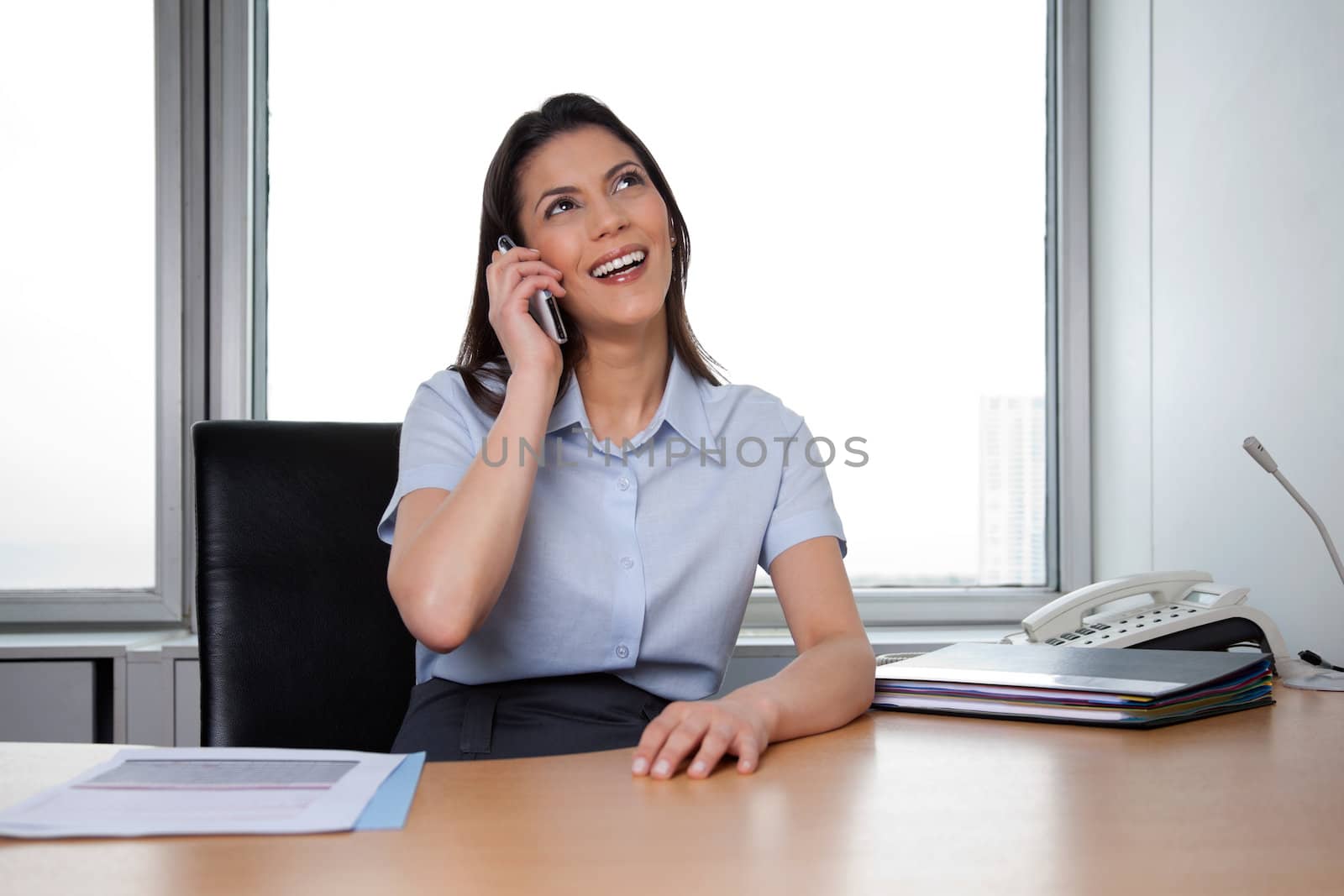 Happy Business woman Talking On Phone by leaf