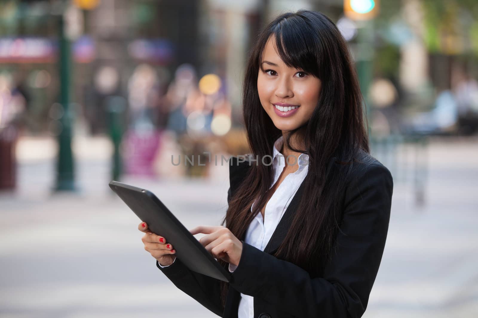 Portrait of businesswoman using tablet pc by leaf