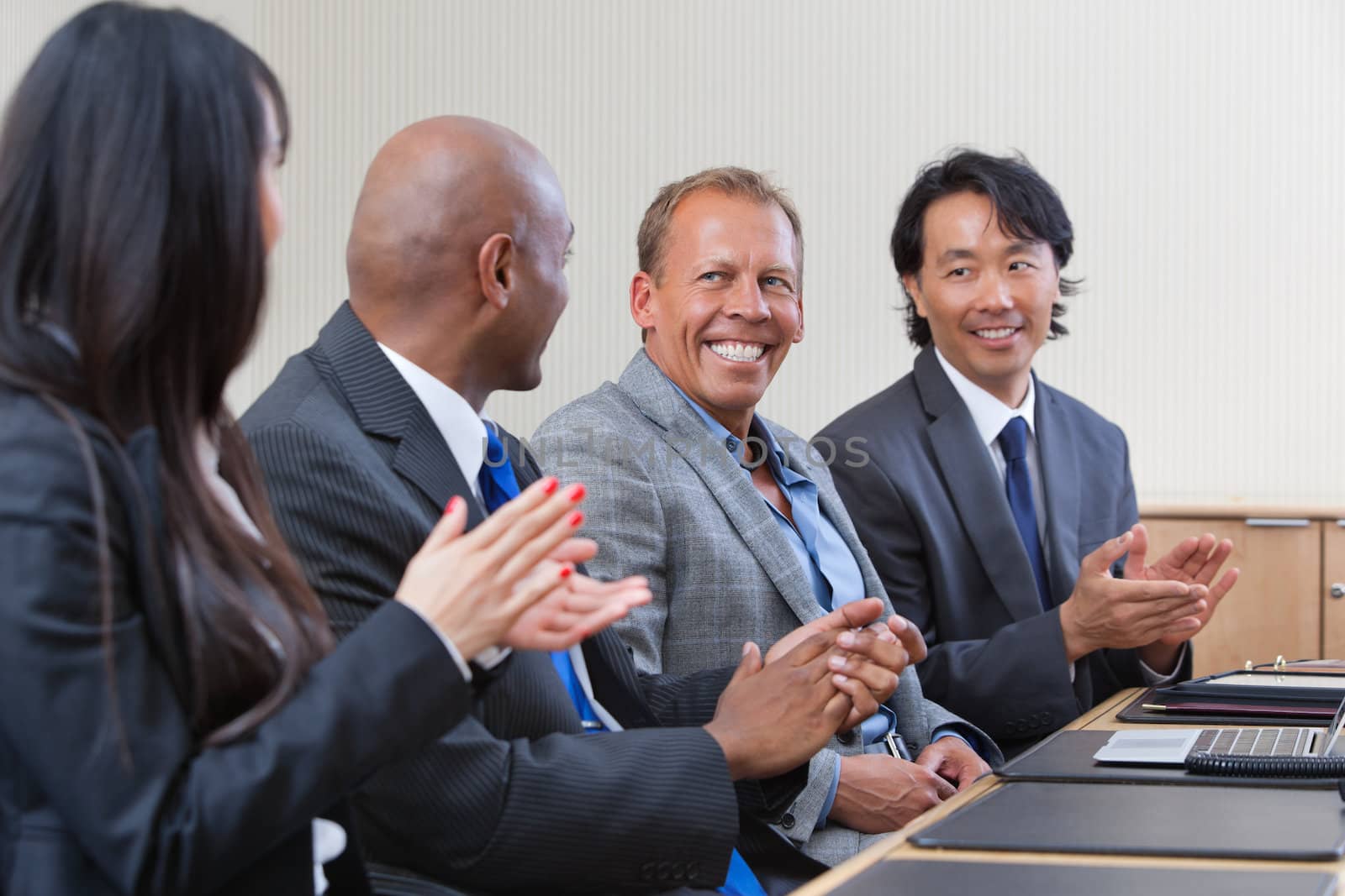 Professionals applauding during a business meeting
