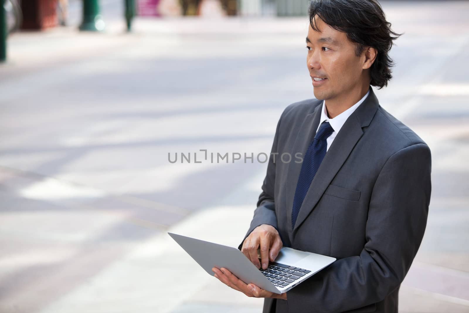 Business Man with Laptop Outdoors by leaf
