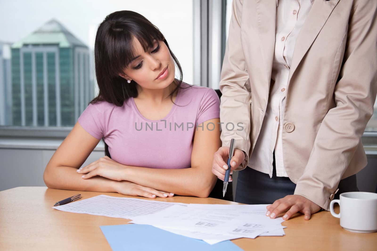 Female executive explaining project plan to her colleague in office