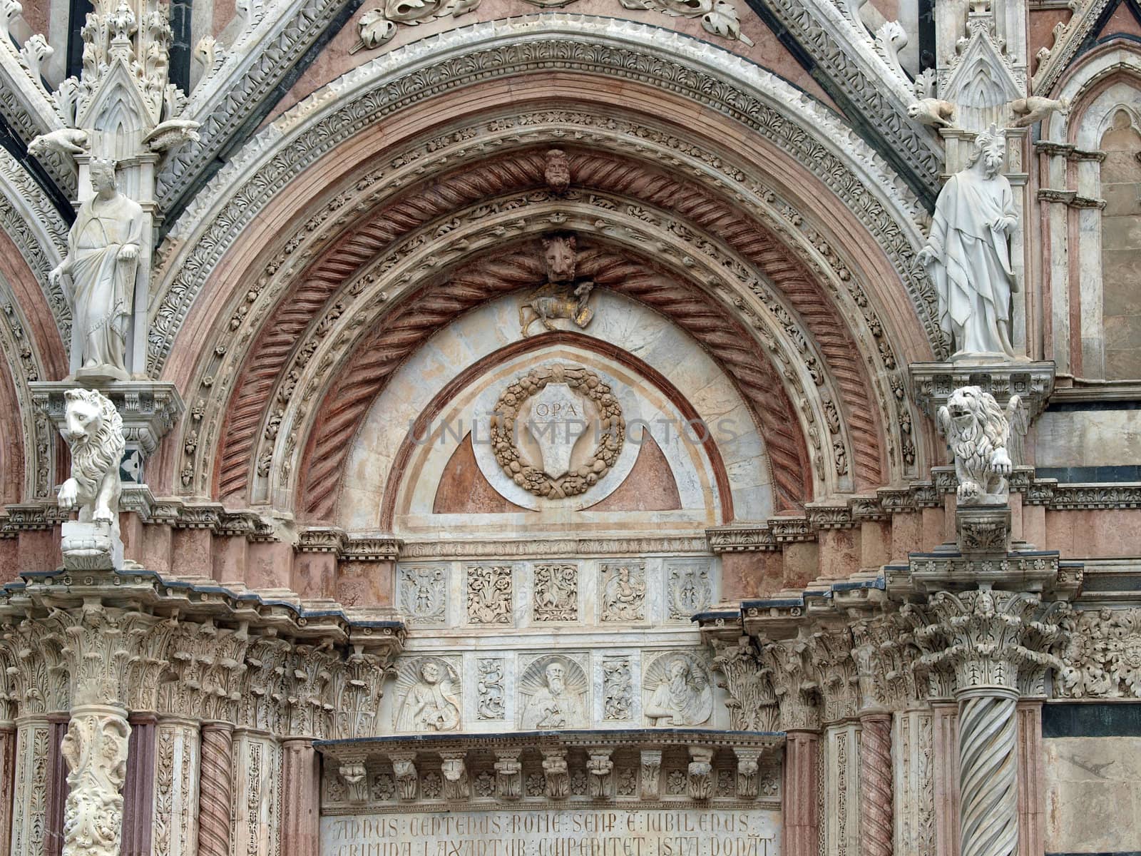 Siena - marble Duomo portal. The Duomo of Siena, which was built in the 12th and 13th centuries, is one of the prettiest churches in Gothic style in Italy