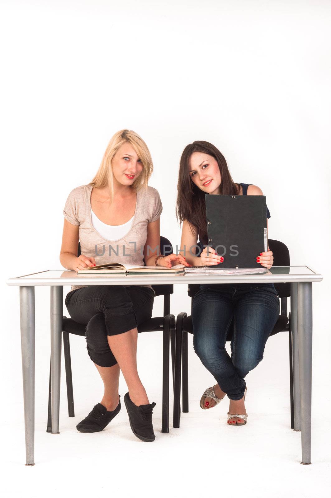 Two beautiful student girls getting ready for school isolated