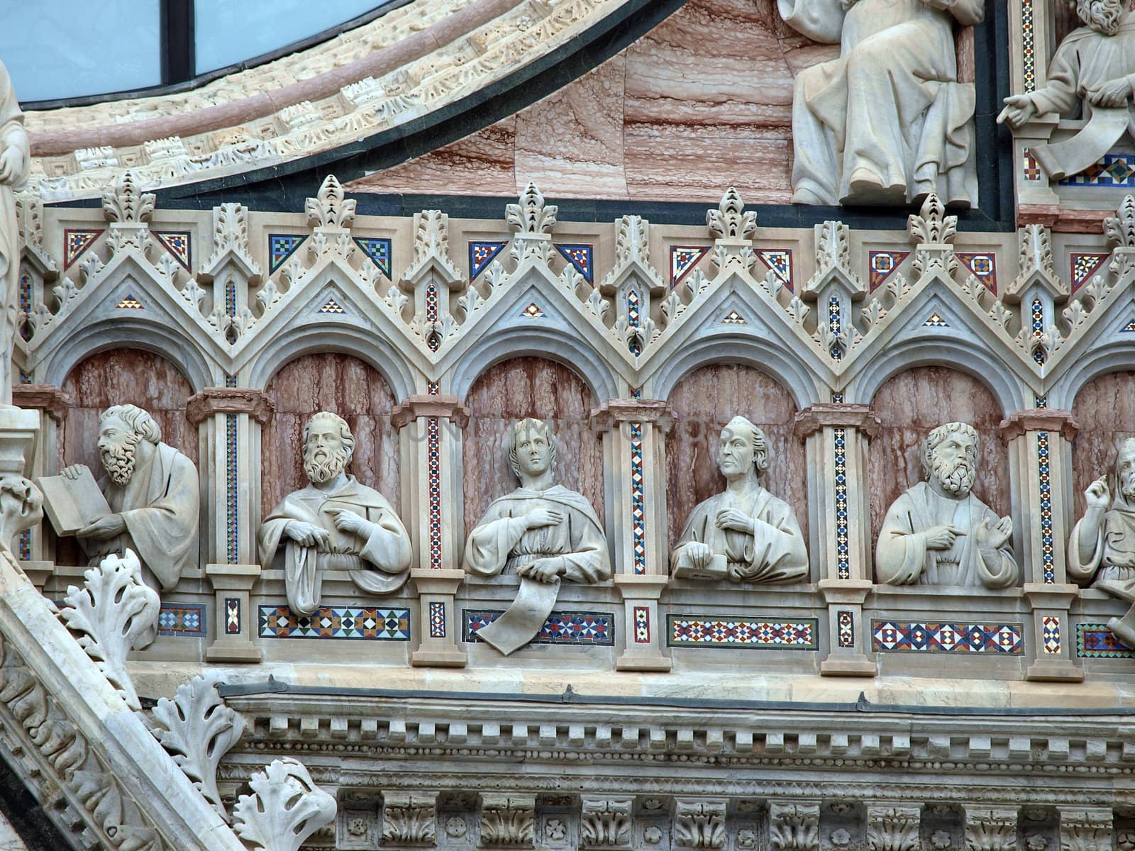 Architectural details of Duomo facade - Siena,Tuscany,Italy. The Duomo of Siena, which was built in the 12th and 13th centuries, is one of the prettiest churches in Gothic style in Italy