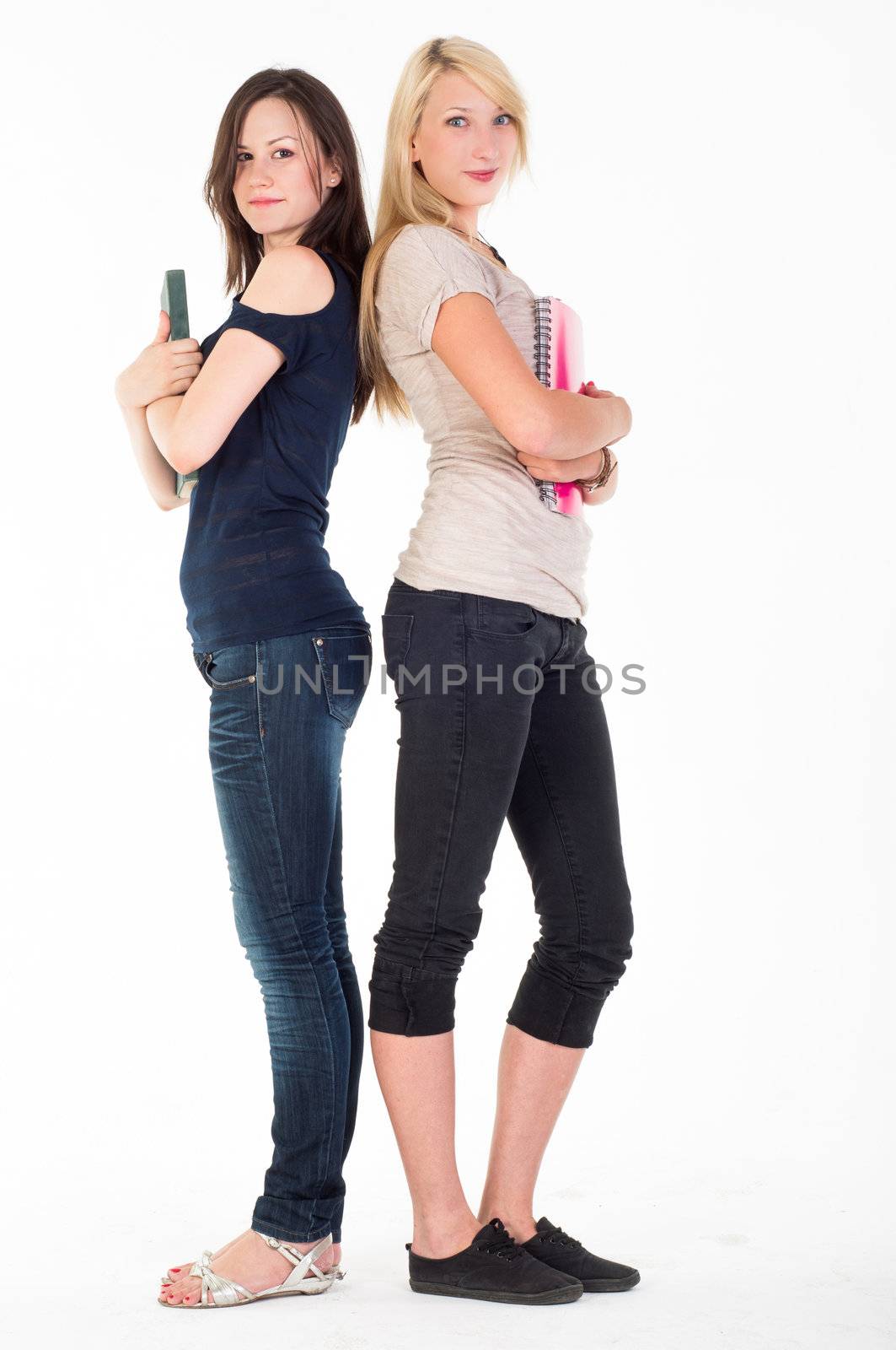 Two beautiful student girls against white background