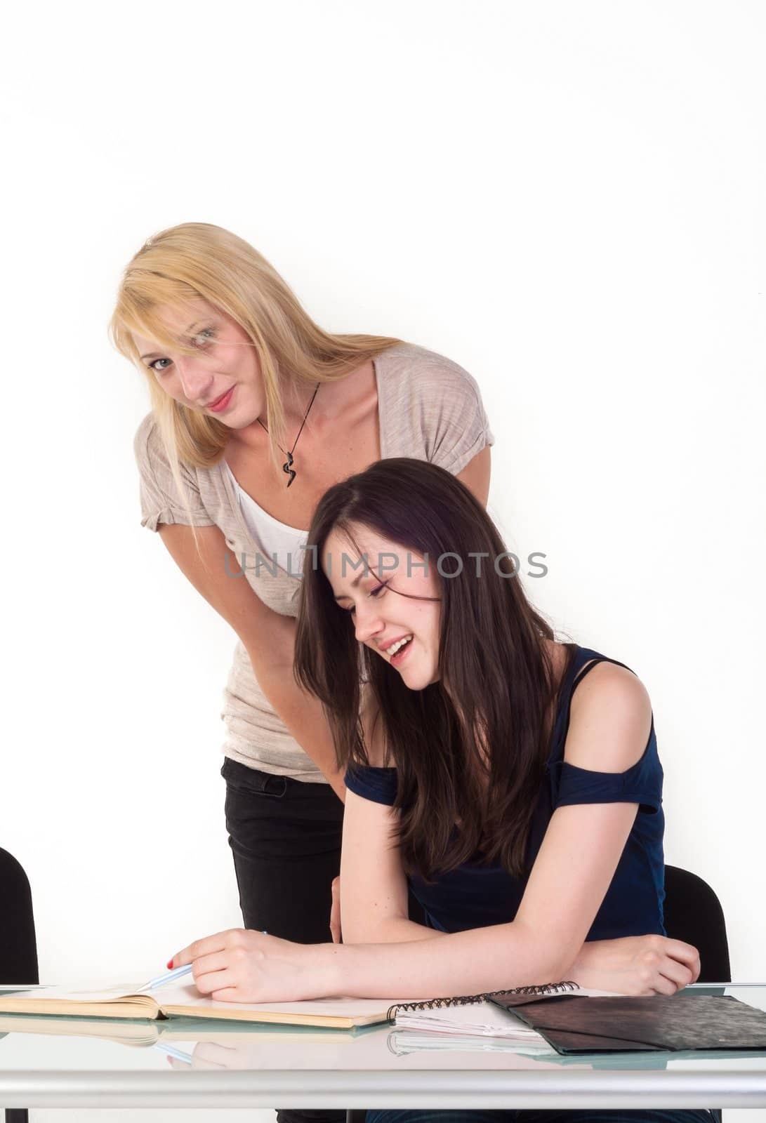 Two beautiful student girls getting ready for school isolated