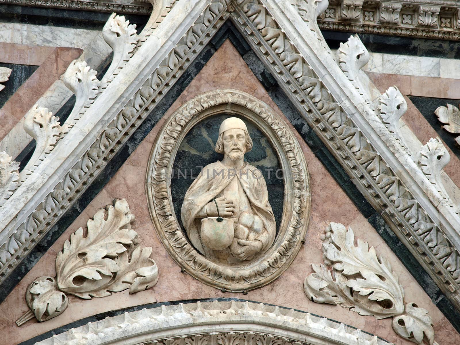 Architectural details of Duomo facade - Siena,Tuscany,Italy. The Duomo of Siena, which was built in the 12th and 13th centuries, is one of the prettiest churches in Gothic style in Italy