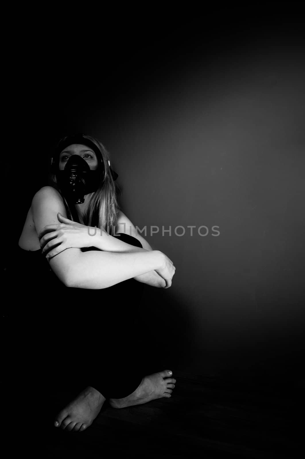 Woman in gasmask against dark background