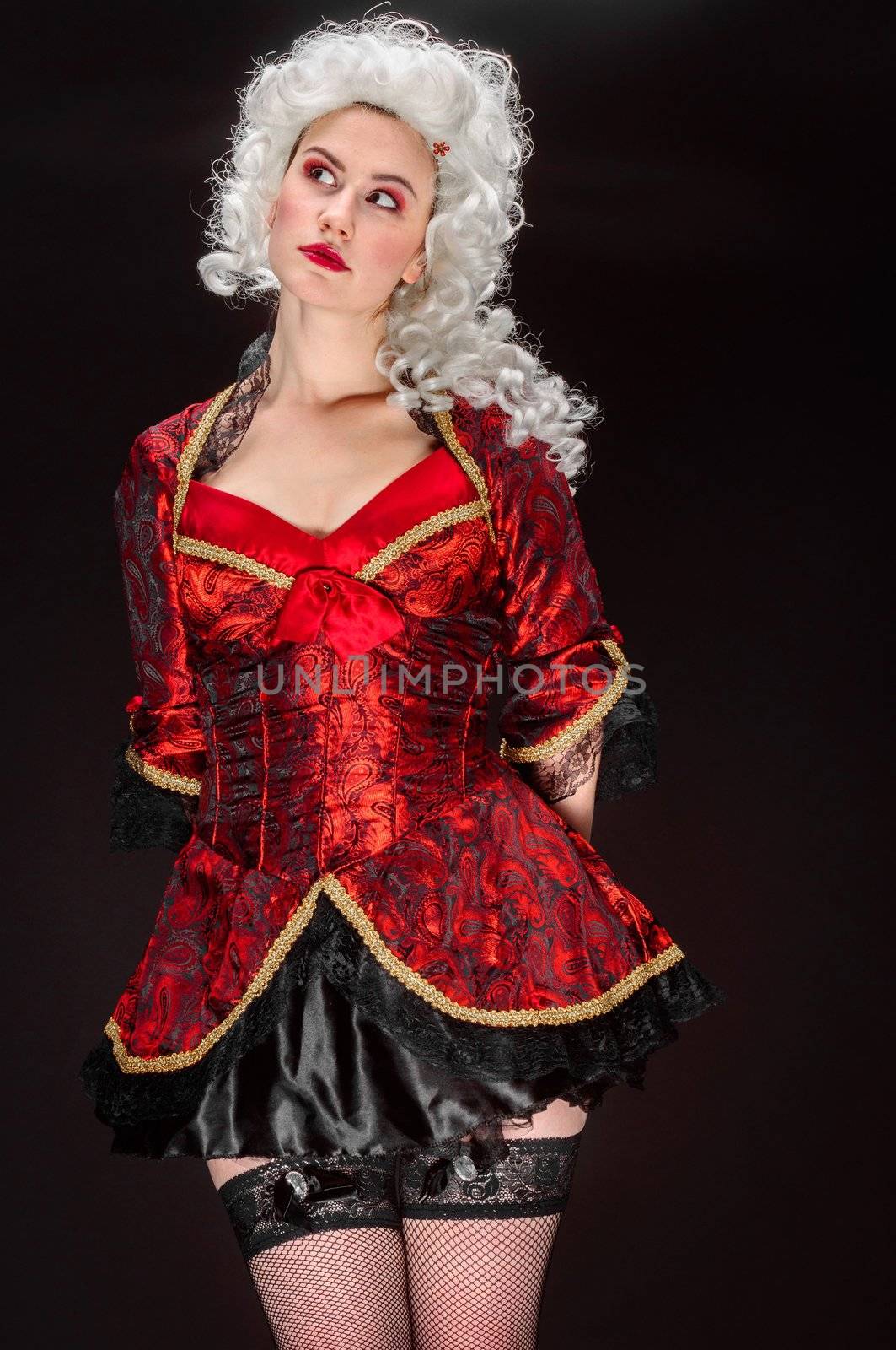 Young woman in baroque costume against dark background