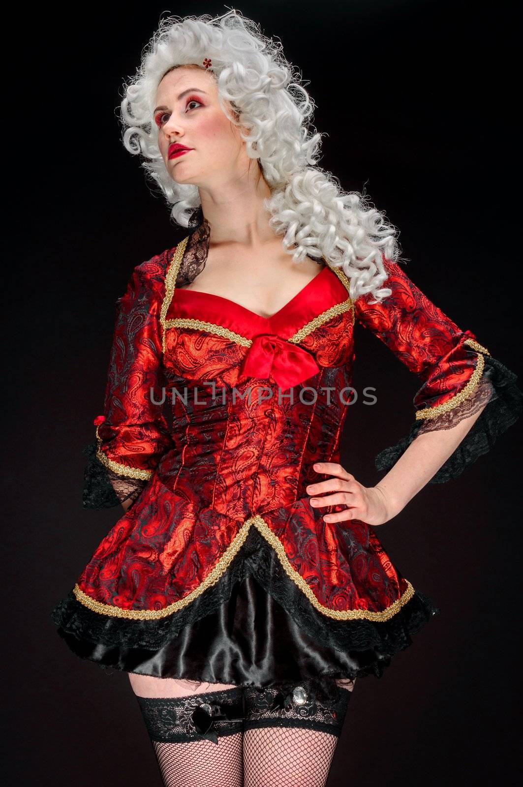 Young woman in baroque custome against dark background