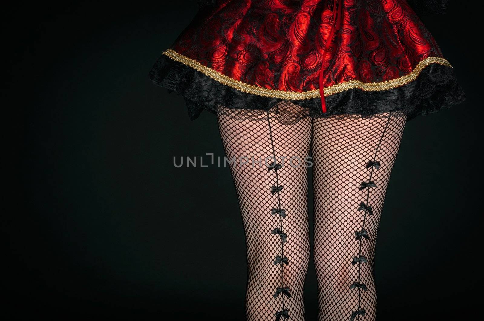 Legs of a youn woman against dark background closeup