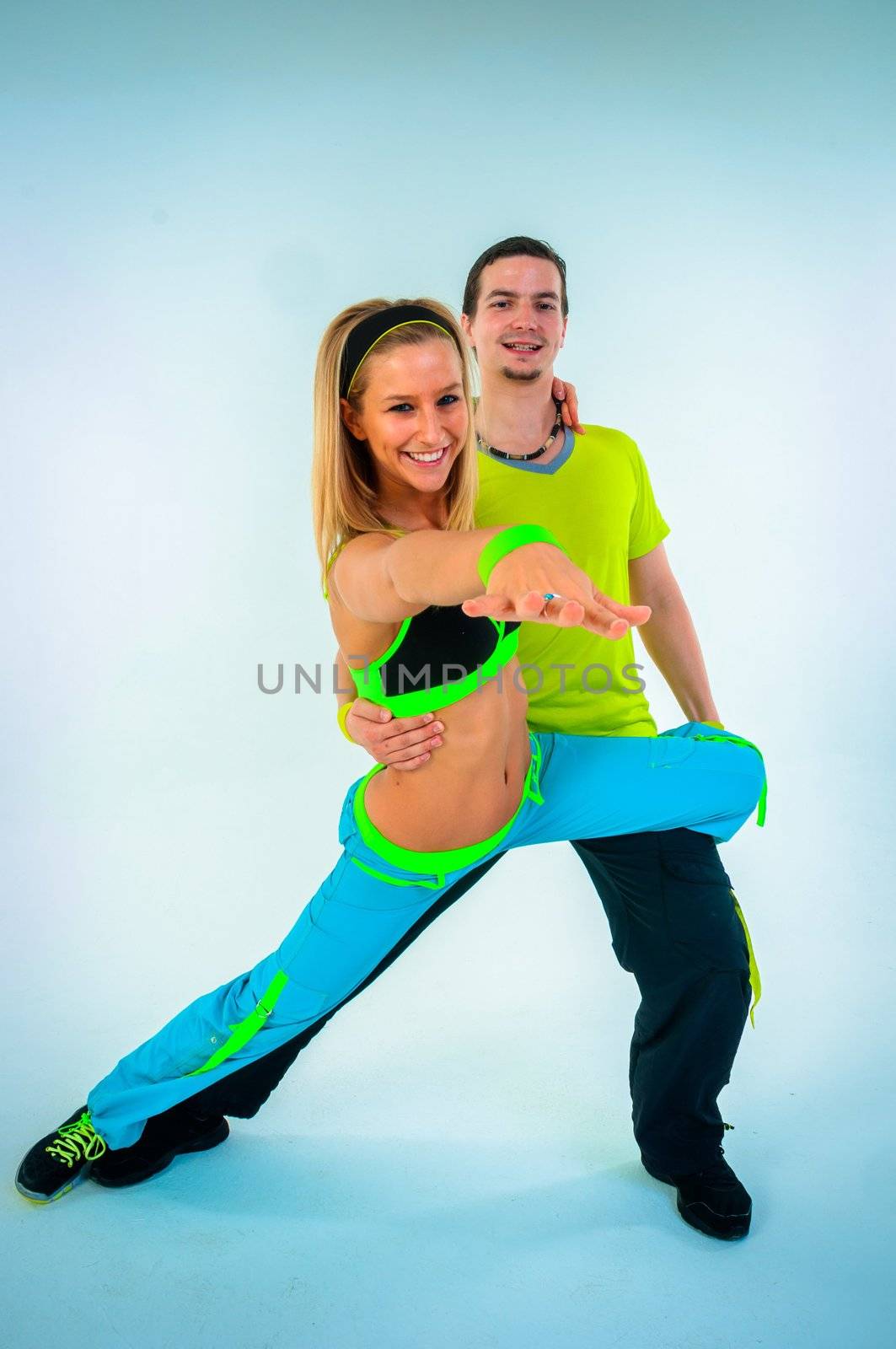 Acrobatic dancing with two young trainers on white background