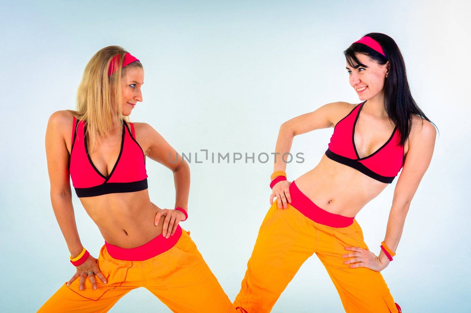 Young fitness instructor girls on isolated white background