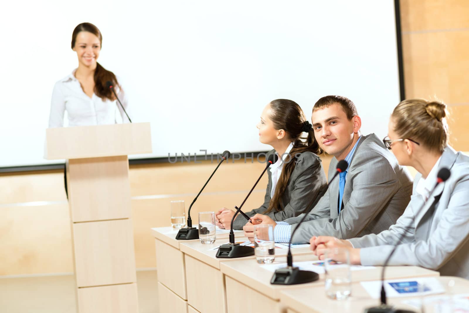 businessmen communicate at the conference, man looking at the camera