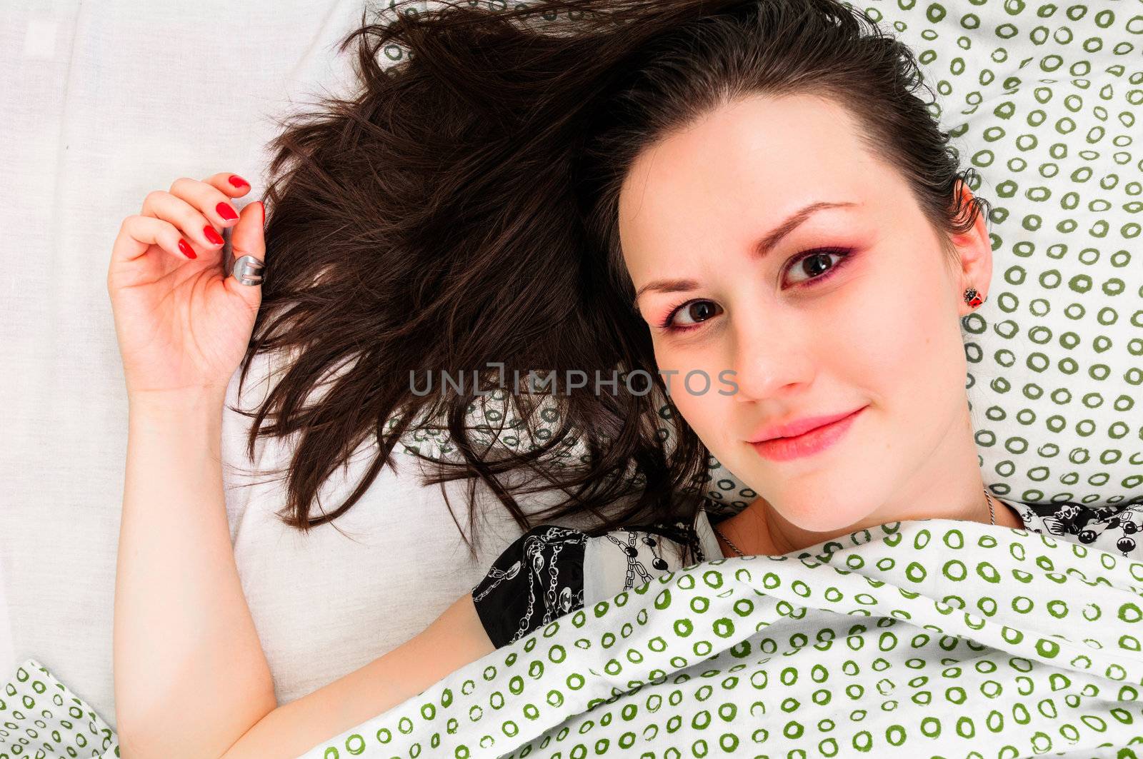 Young woman in the bed in bright light