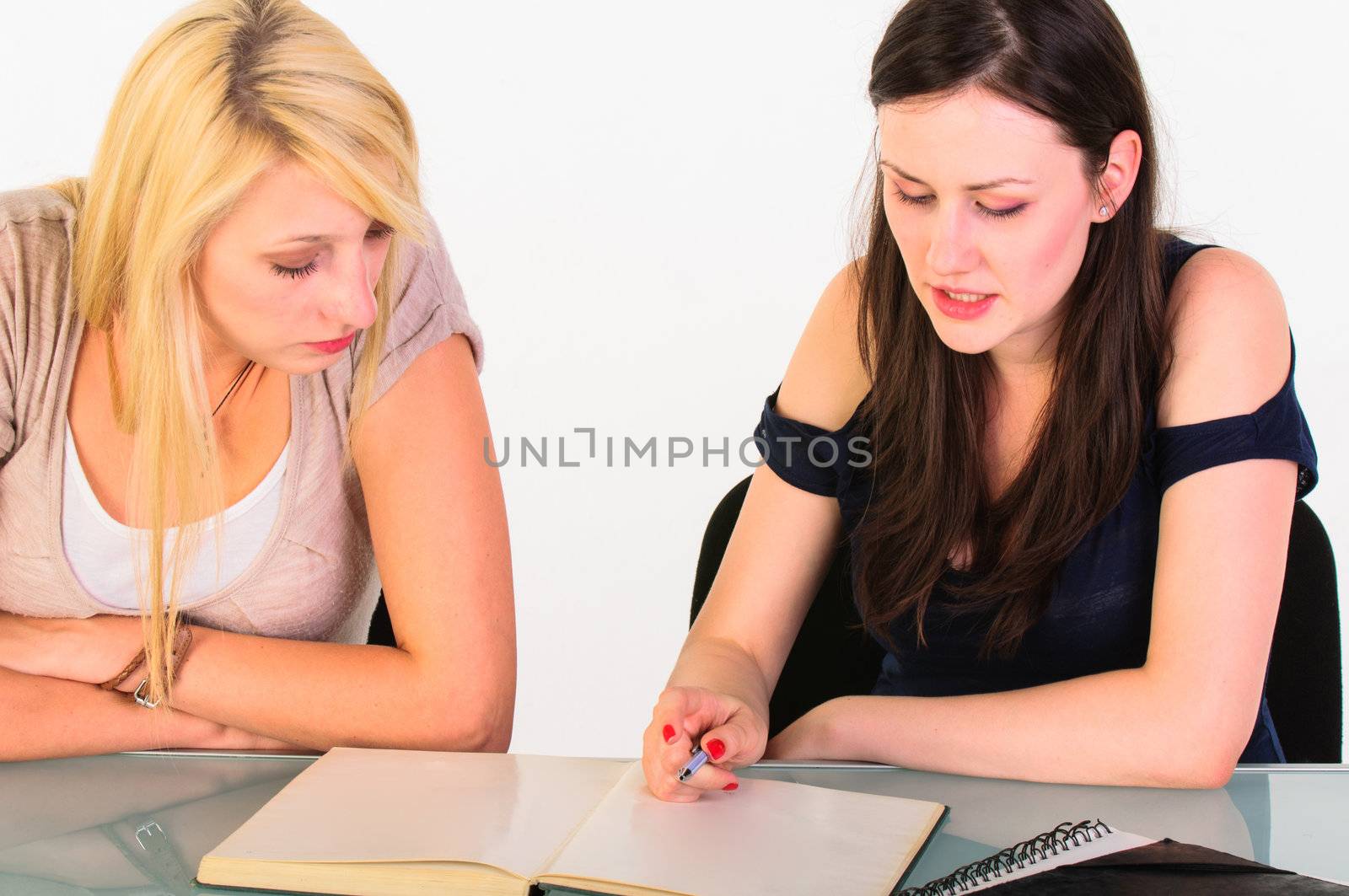 Two beautiful student girls getting ready for school isolated