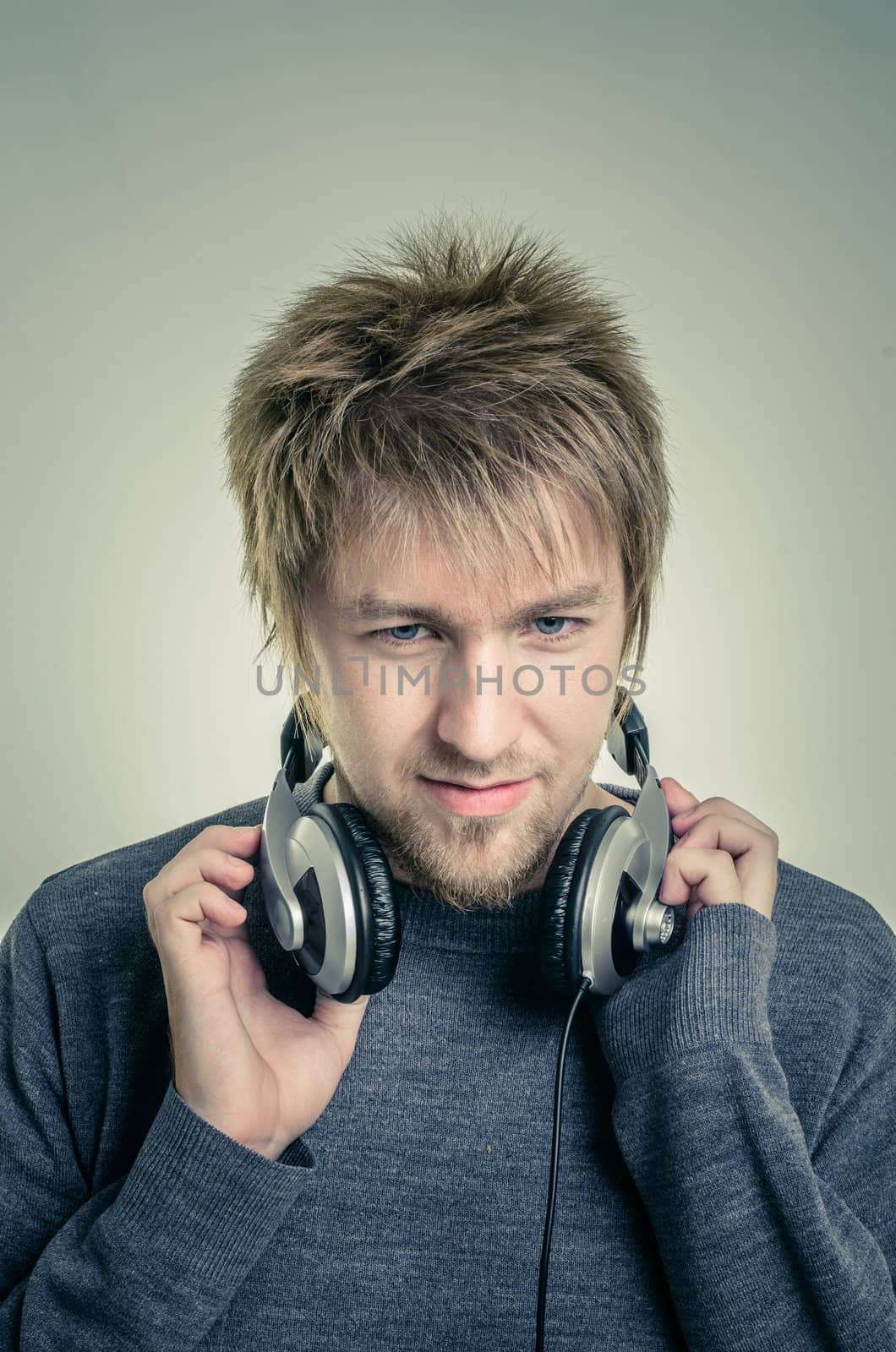 Young man with headphones against white background