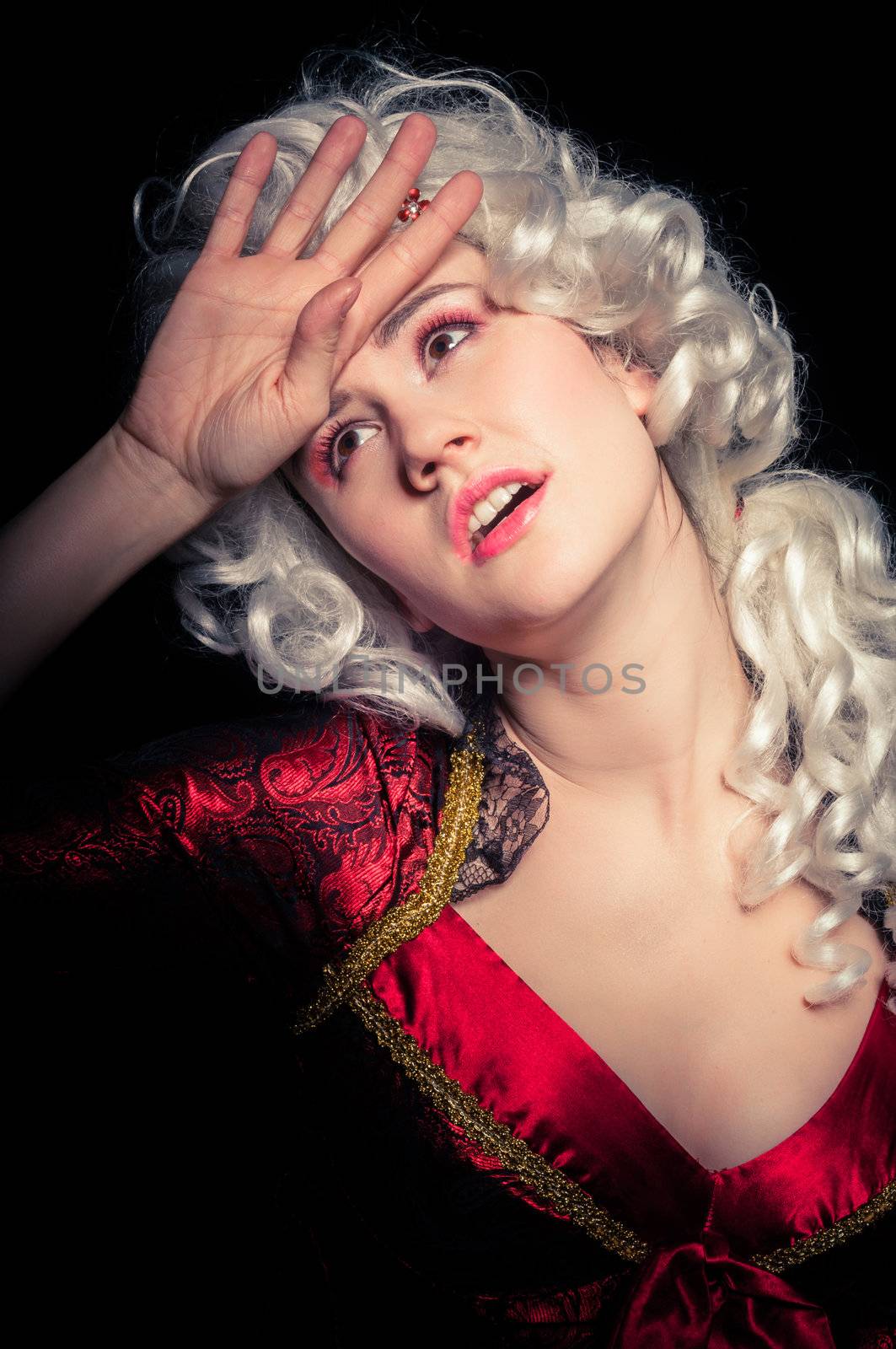 Young woman in baroque custome against dark background