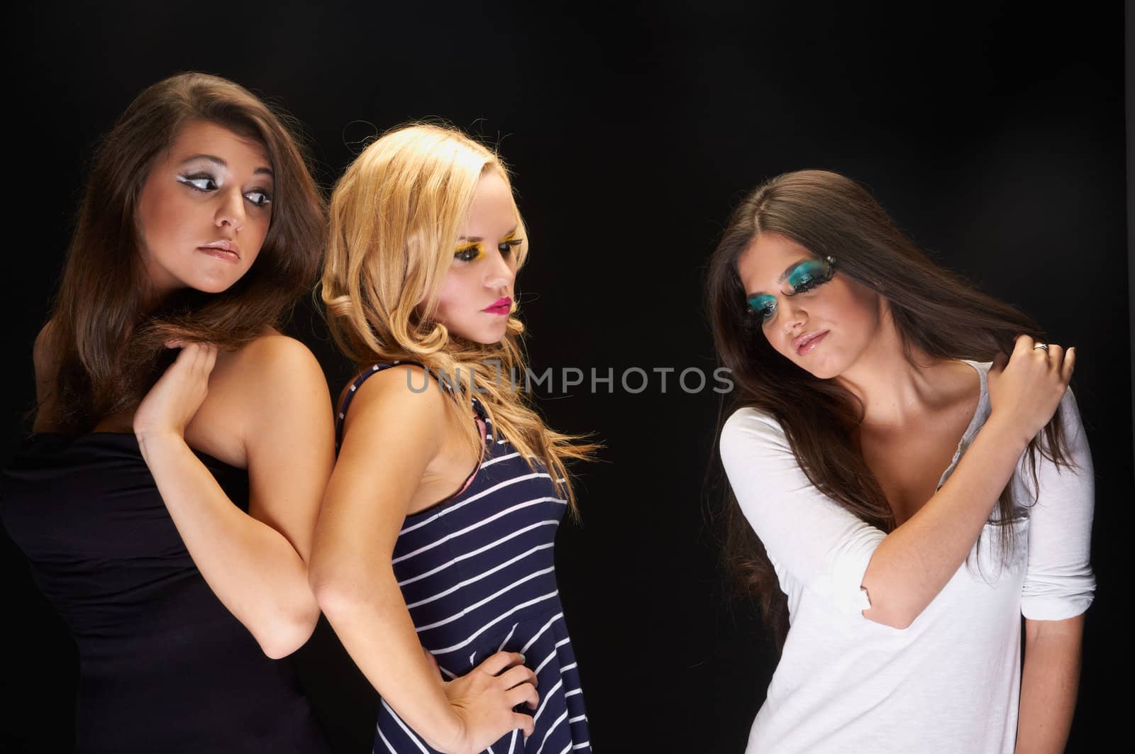 A group of young models against dark background a the studio