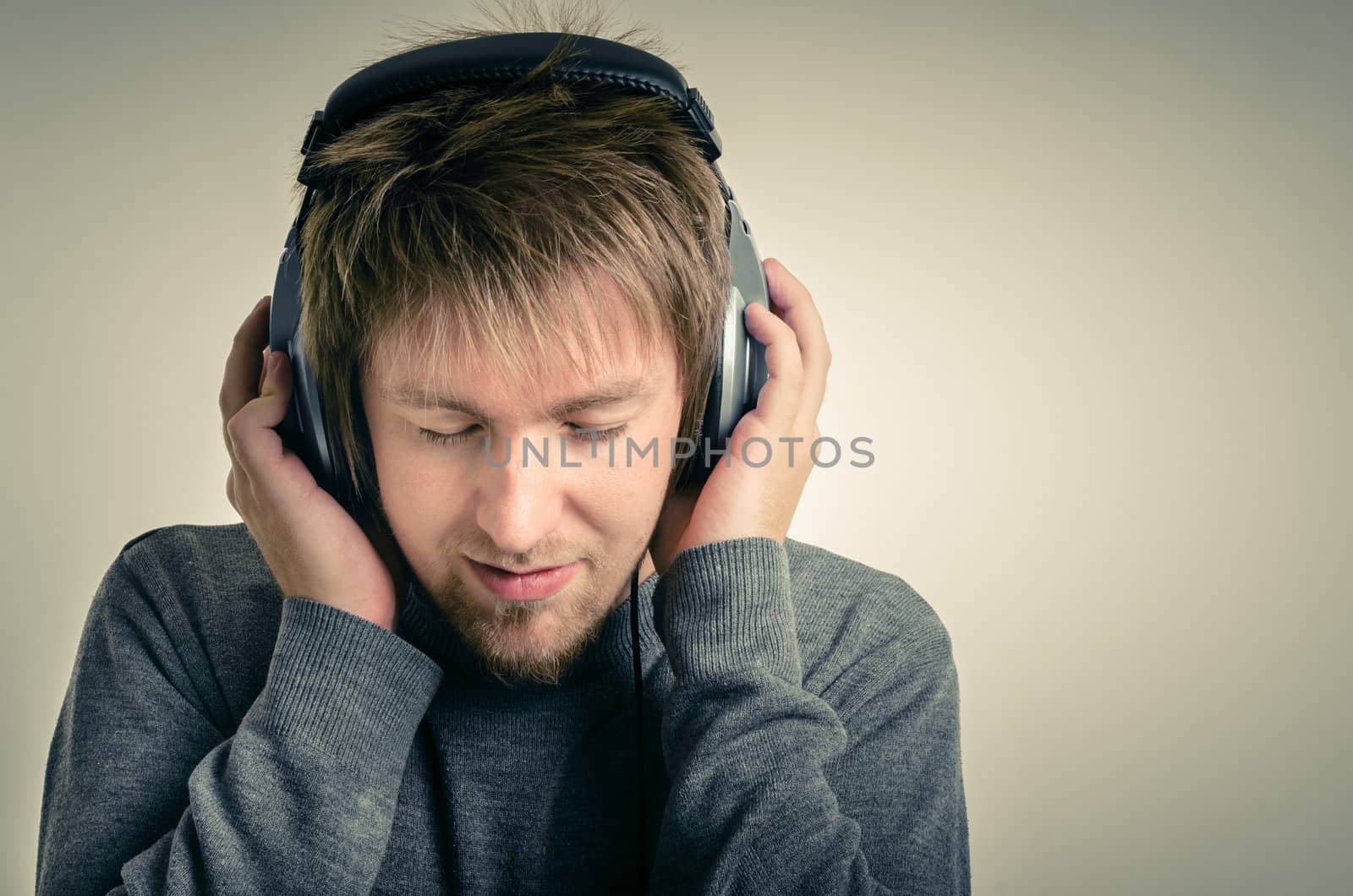 Young man with headphones against white background