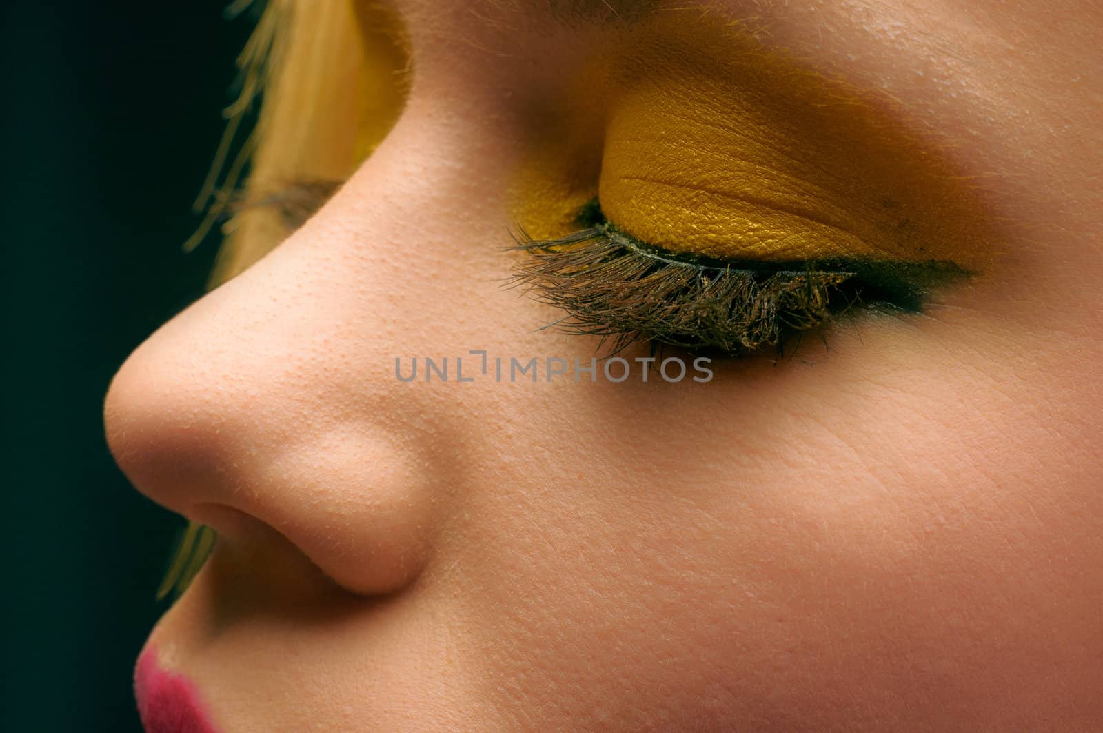Closeup photo of a beautiful girl with yellow makeup
