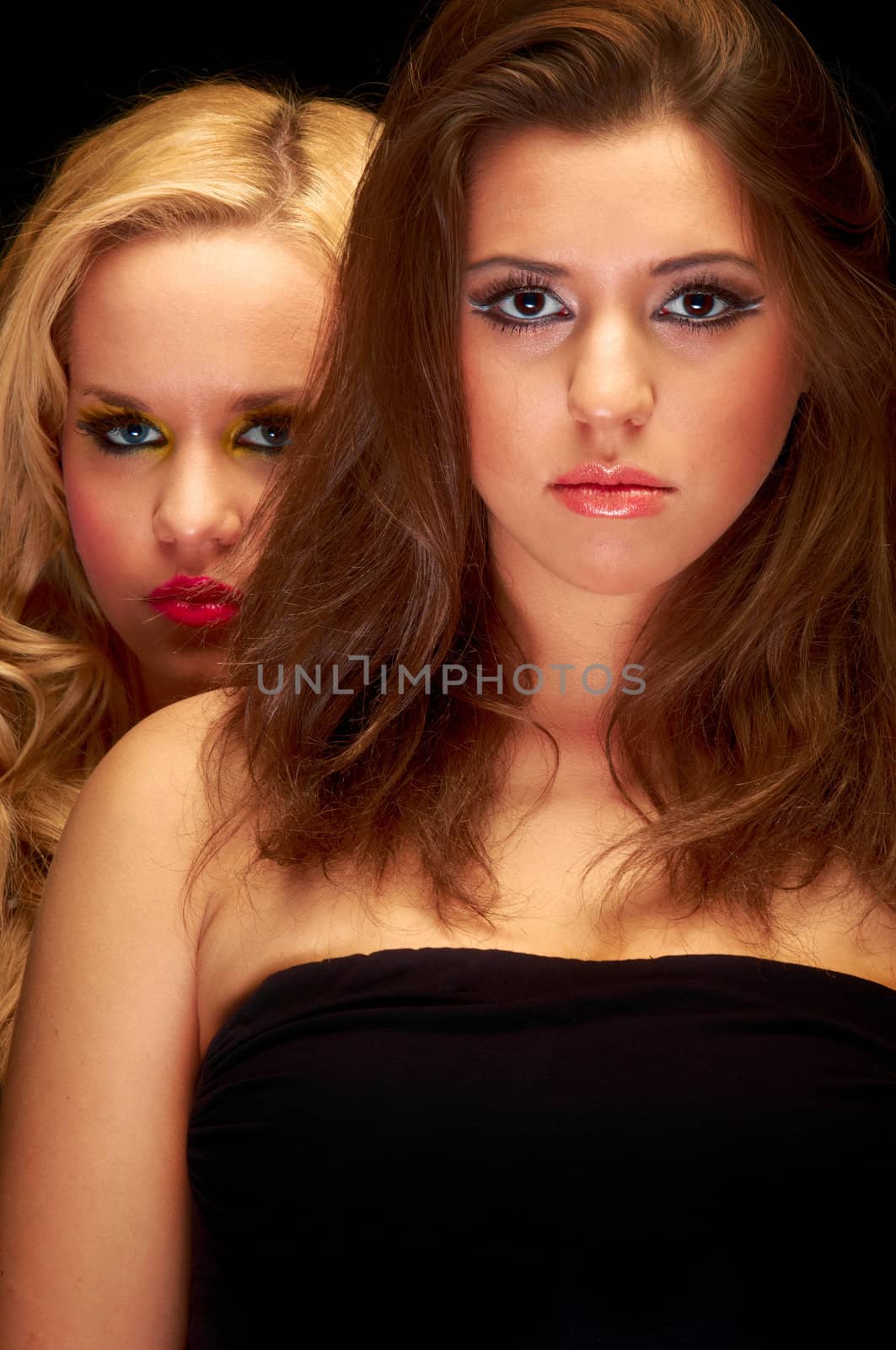 Closeup photo of two young girls in the studio by svedoliver