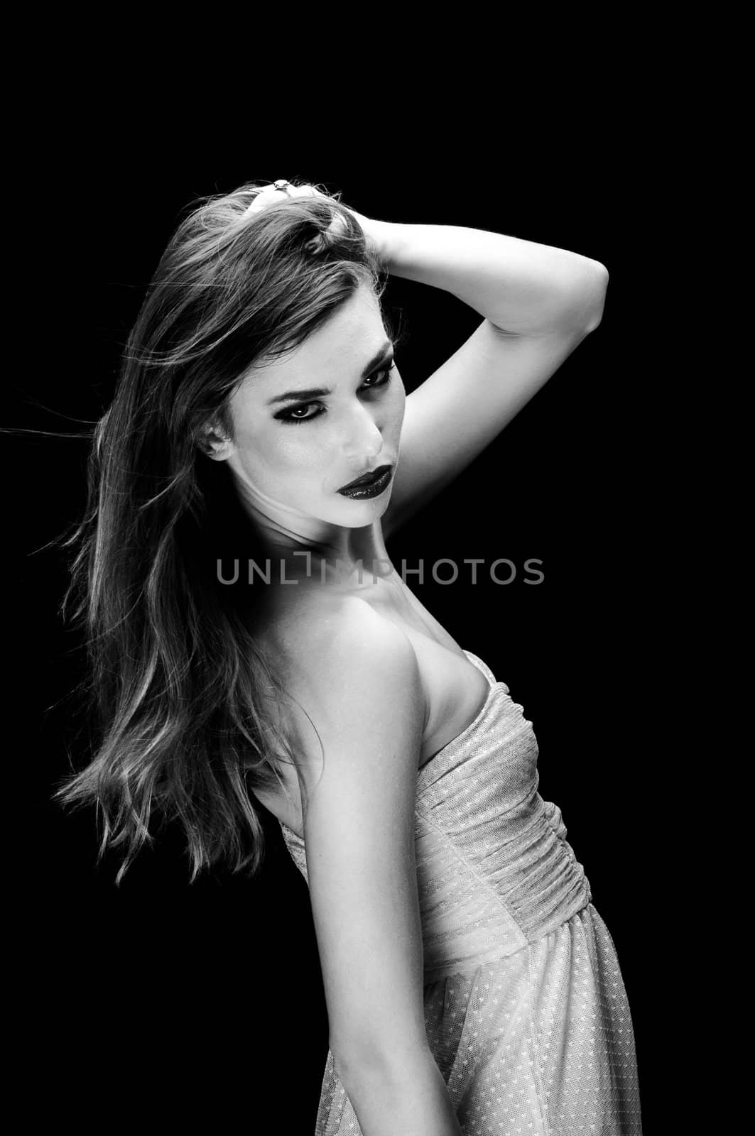 Beautiful young woman against dark background