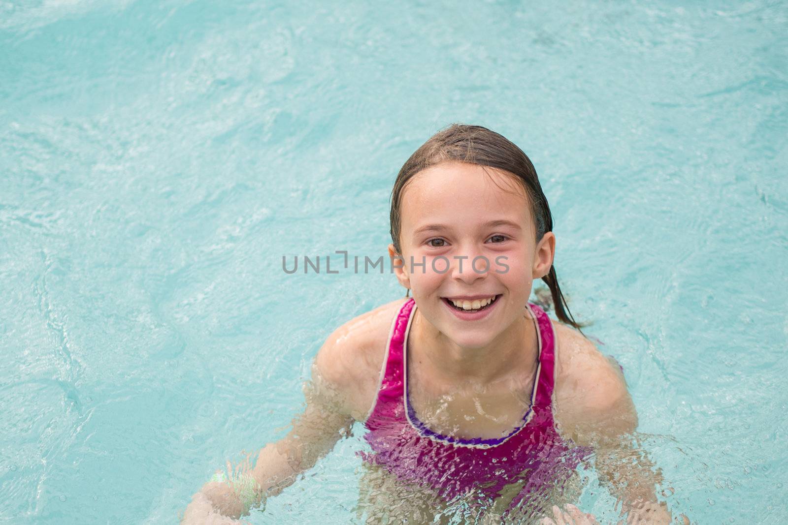 Smiling girl in a swimming pool