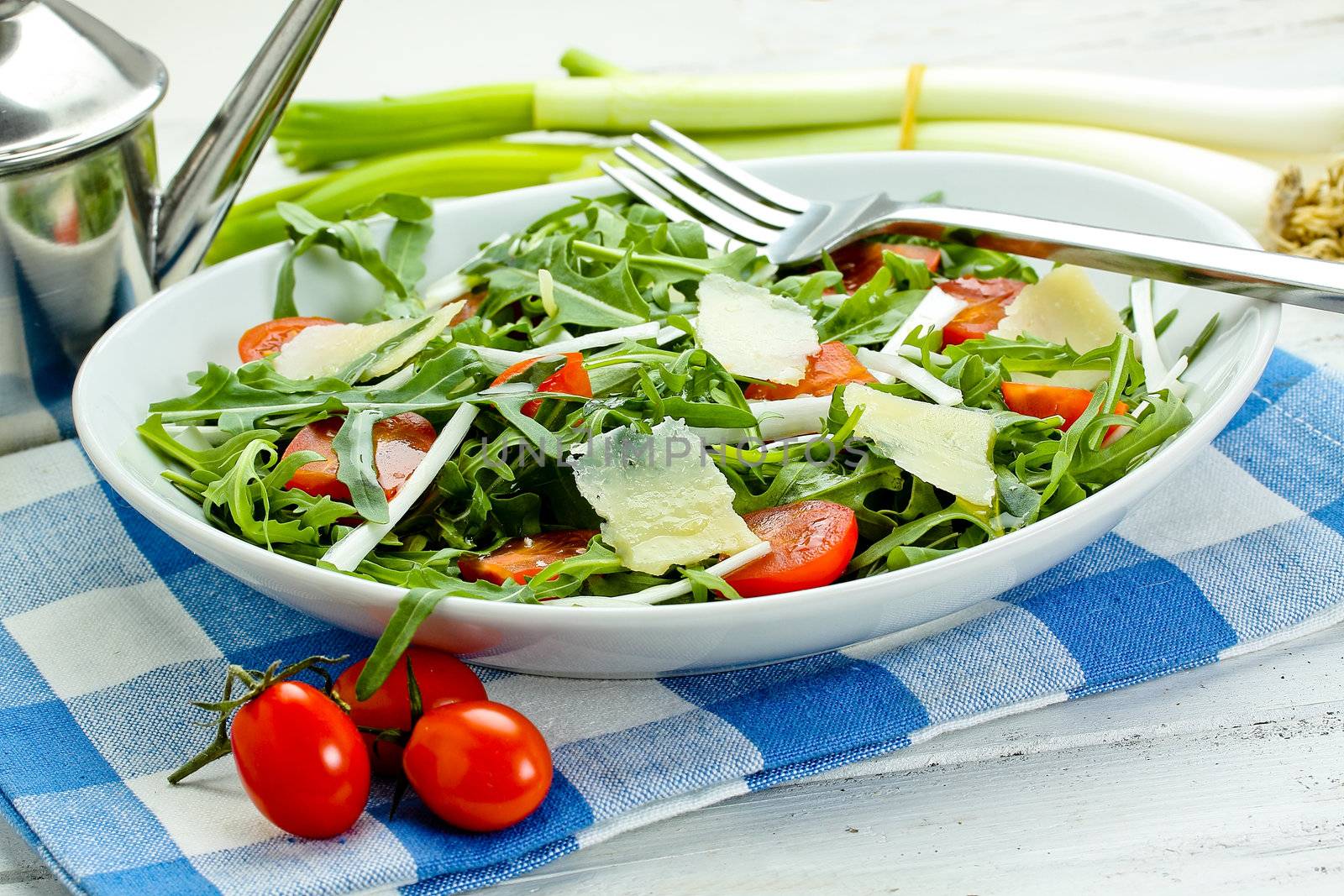 salad with arugula, cherry tomatoes, parmesan and shallot