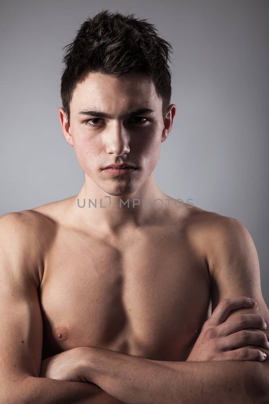 Portrait of young bodybuilder man on a black background