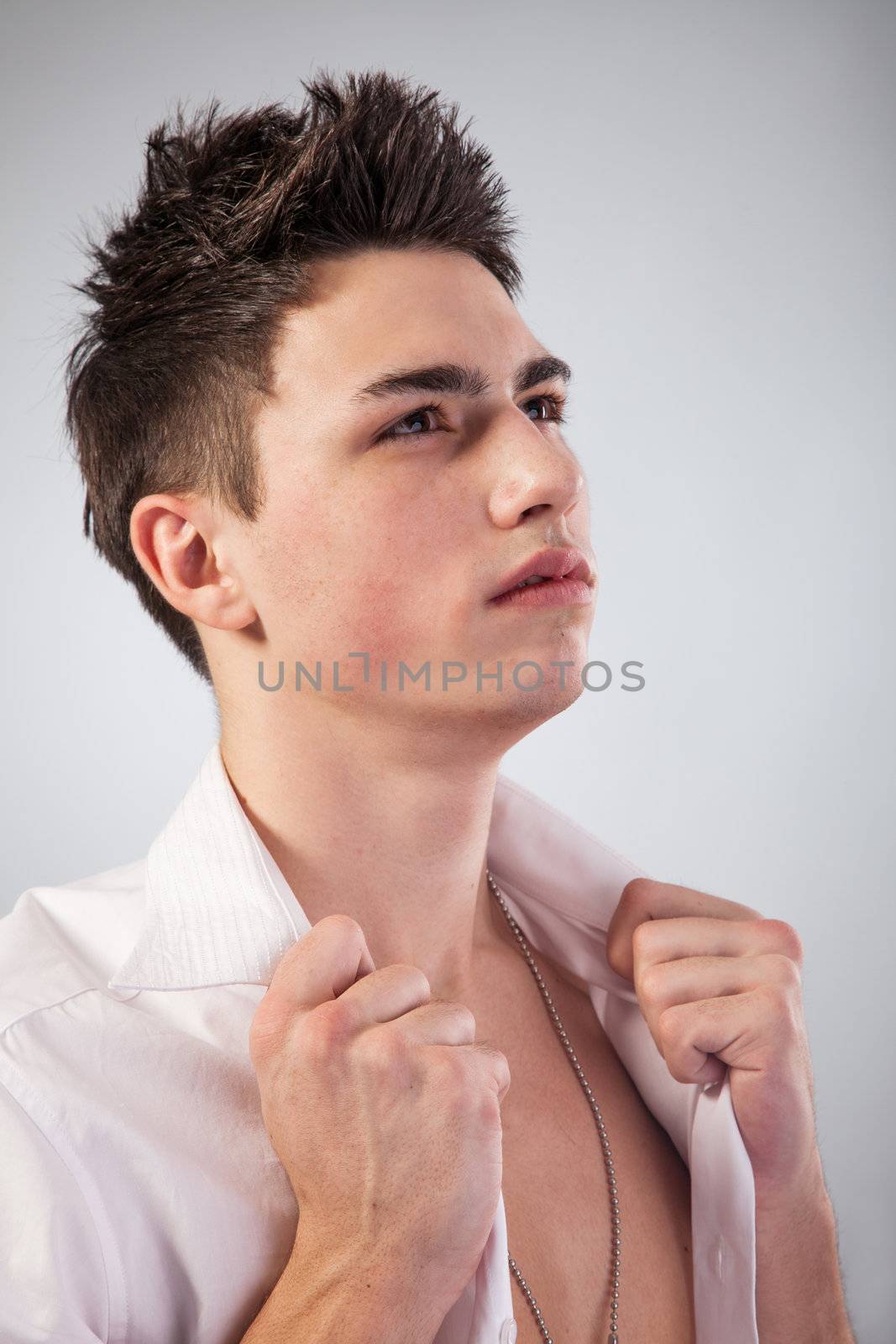 Healthy muscular young man. Isolated on grey background.