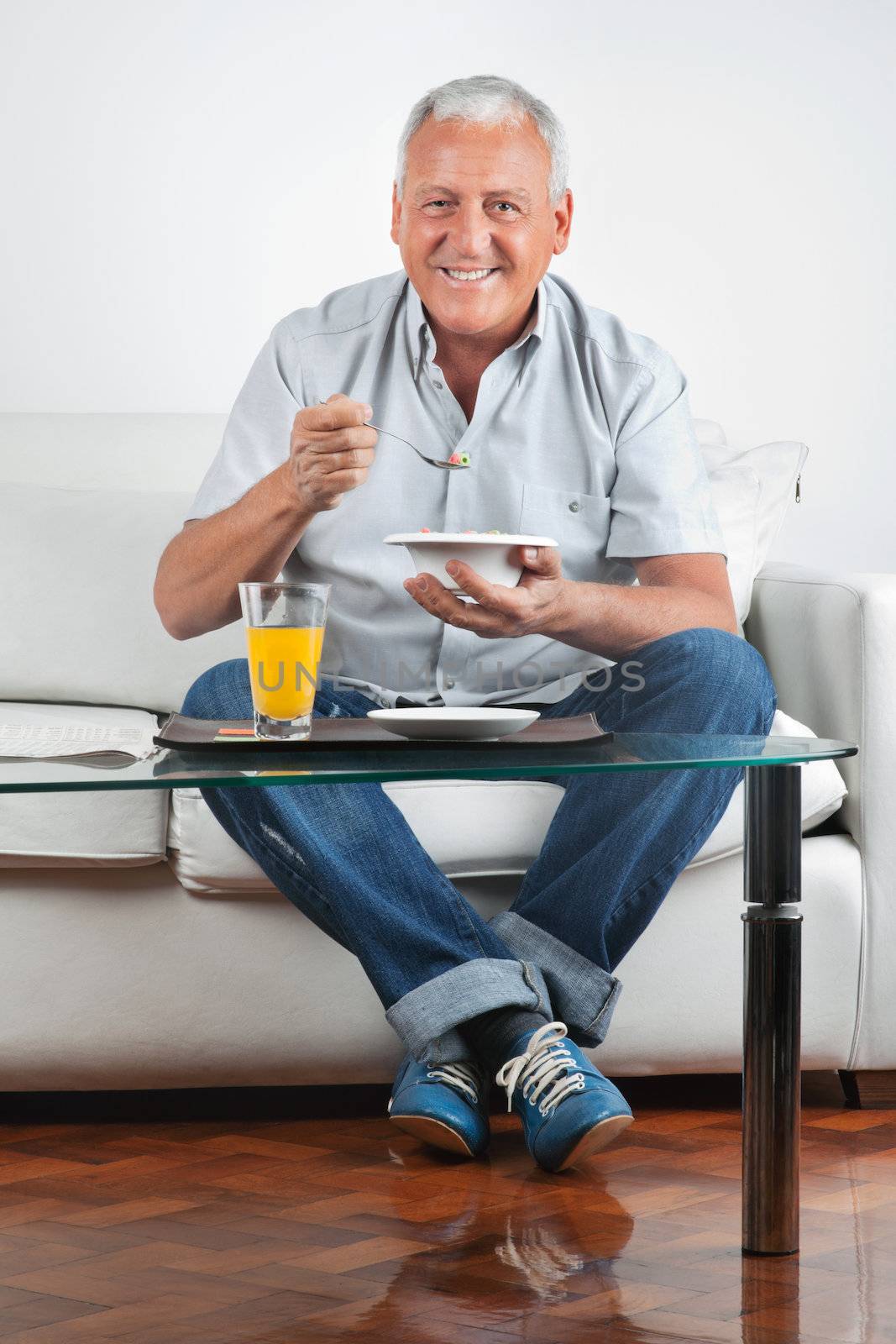 Senior Man Having Breakfast by leaf